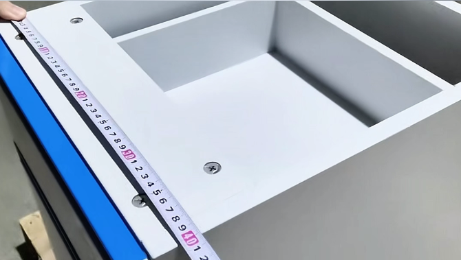 MeCanMed’s inspector use a measuring tool to verify lab bench dimensions against blueprints.