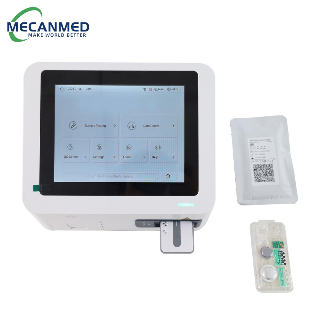 A MECANMED dry electrolyte analyzer unit on a white surface, with its test card inserted and quality control materials nearby.