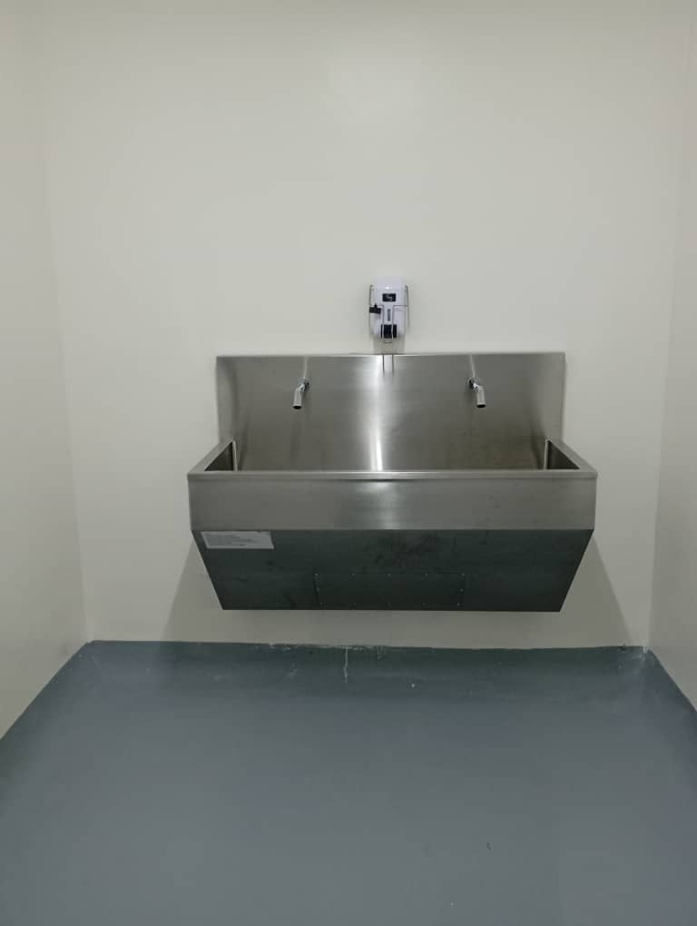 Stainless steel medical scrub sink installed by MeCanMed in a Rwanda hospital operating room.