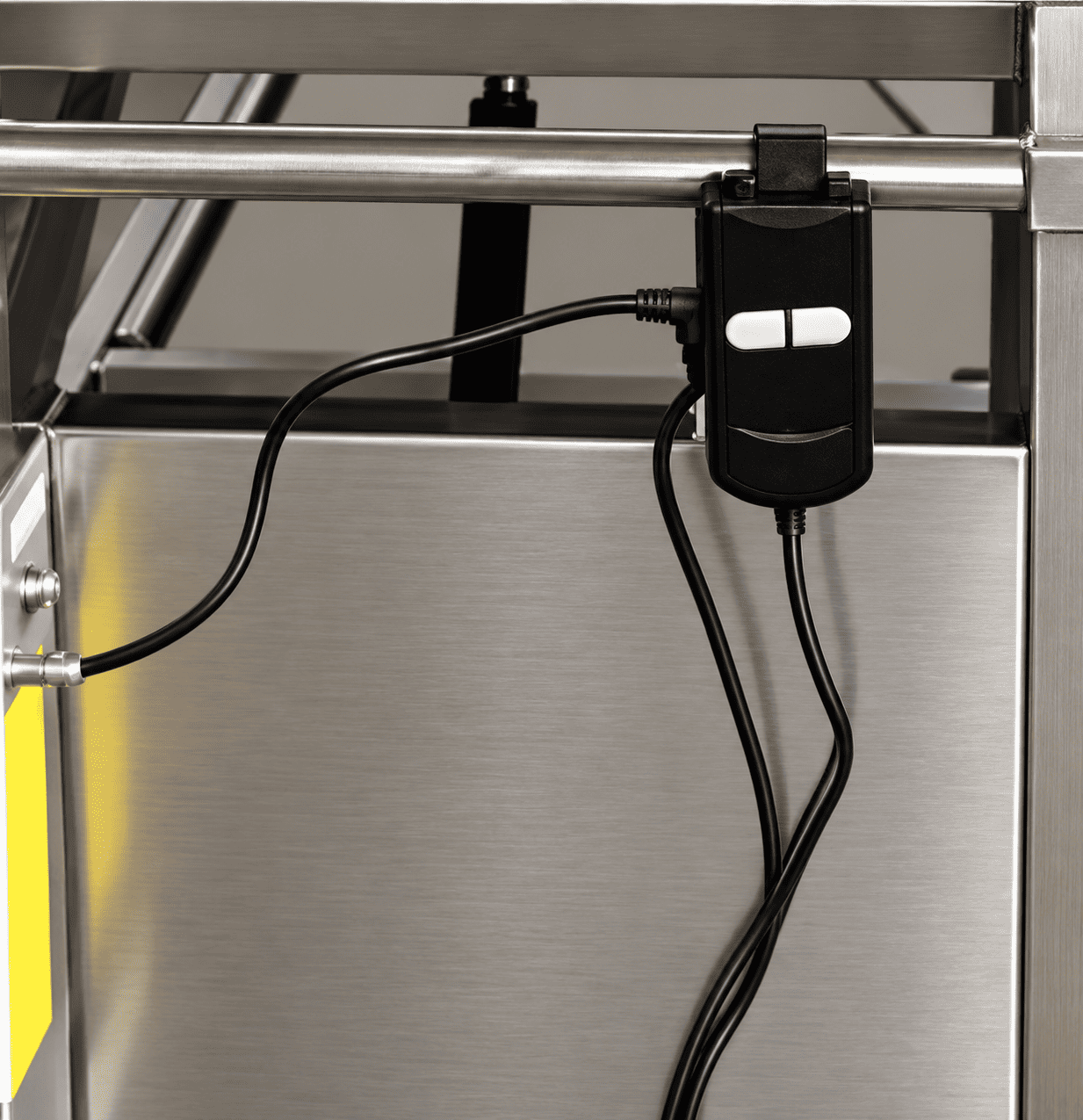 Handle-mounted control switch for raising and lowering the MCM0032 electric mortuary trolley platform.