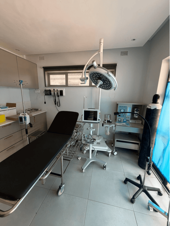 Fully operational MeCanMed operating room including surgical light, monitor, and anesthesia machine in Zimbabwe.
