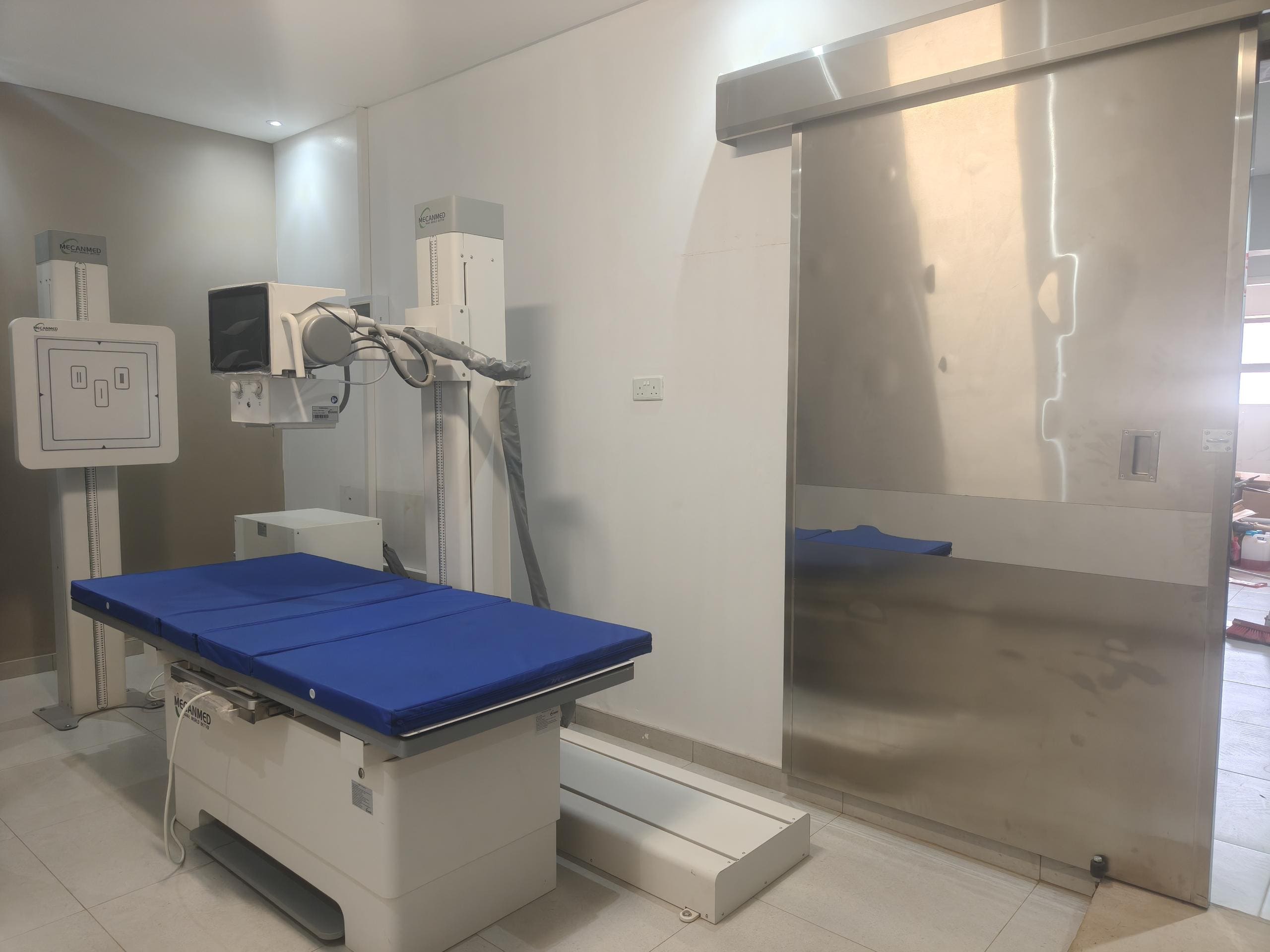 Installed MeCanMed X-ray machine in a new Zimbabwe hospital radiology department during an on-site check.